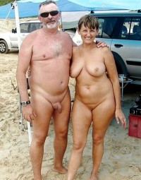 Mom with huge flabby tits and shaved pussy with dad's shaved cock with long foreskin posing nude on a beach