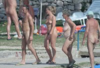 Nudist family walking on the beach and showing my small hairy semi-erected dick with my wife's flabby tits and hairy twat