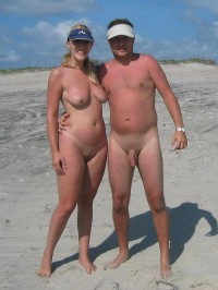 Nudist photo of young teen couple showing guy's semi-hard uncut dick and girl's flabby tits and trimmed cunt
