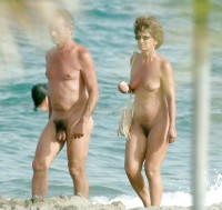 Old hairy nude couple at the walk on the beach
