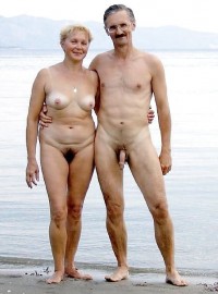 Older couple on a beach posing nude with woman's big hairy cunt and small flabby tits and man's uncut hairy cock