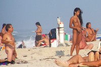 Older guy on the nude beach with small semi-hard hairy dick looking at some young girl with small tits and trimmed pussy
