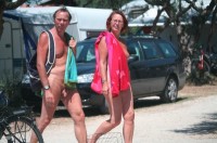 Photo from nudist camp showing older guy with fat uncut shaved dick and older woman with saggy breasts and hairy pussy