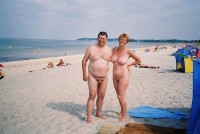 We are laughing together at husband's tiny shaved cock with his wife's big flabby tits and huge shaved pussy on a beach