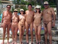 Whole nudist group posing nude and showing small shaved cocks and girls with saggy breasts and trimmed shaved cunts