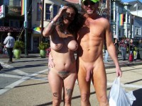 Nude couple on the square showing guy's huge shaved monster dick and woman's long clit and huge firm tits
