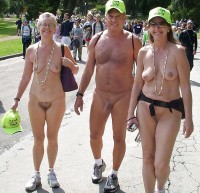 Old couple walking nude at a nude parade and showing women's hairy pussies and flabby tits and man's semi-erected shaved dick