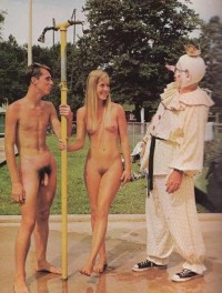 Teen girl wiith small firm tits and hairy twat with her boyfriend's curvy hairy penis smiling at some weird clown