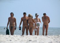 Walking nude on a beach and proudly showing my firm tits and shaved cunt to my boyfriend's small shaved dick